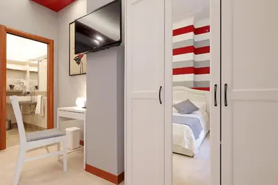 a room with a bedroom with a bed and a tv at Olafo’s house in Rome