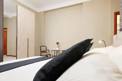 a bedroom with a large bed and a table at Olafo’s house in Rome