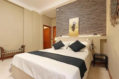 a bedroom with a large bed and a brick wall at Olafo’s house in Rome