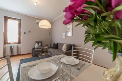 a living room with a table and a couch at Augustus Suite near Saint Peter in Rome