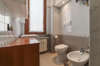 a bathroom with a toilet and a sink at Augustus Suite near Saint Peter in Rome