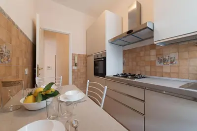 a kitchen with a table with a bowl of fruit on it at Augustus Suite near Saint Peter in Rome
