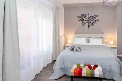 a bedroom with a bed and a large window at La RomAntica Roma in Rome