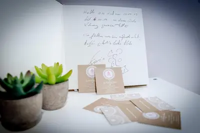 a table with two potted plants and a letter at La RomAntica Roma in Rome