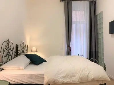 a bedroom with a white bed and a window at Cozy flat in Rome in Rome
