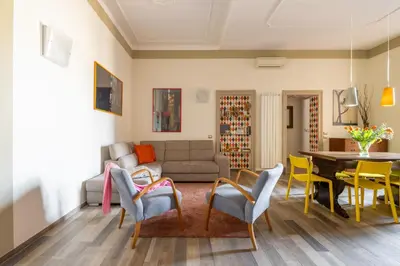 a living room with a couch and a table and chairs at HospitalityRome Domus Aureliana in Rome