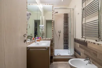 a bathroom with a sink and a mirror at HospitalityRome Domus Aureliana in Rome
