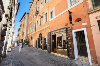 a woman walking down a street next to buildings at Maison d'Art Apartments - Maison d'Art Collection in Rome