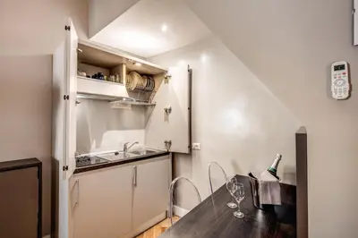 a kitchen with a wooden table and a sink at Maison d'Art Apartments - Maison d'Art Collection in Rome