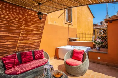 a patio with two chairs and a bath tub at Maison d'Art Apartments - Maison d'Art Collection in Rome