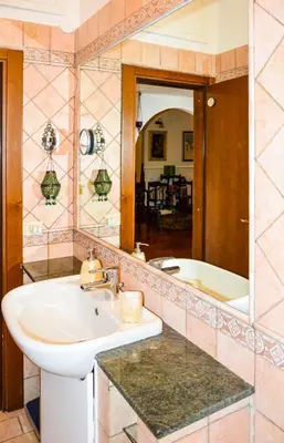 a bathroom with a sink and a tub and a mirror at House Candia 111 - Vatican Museum apartment in Rome