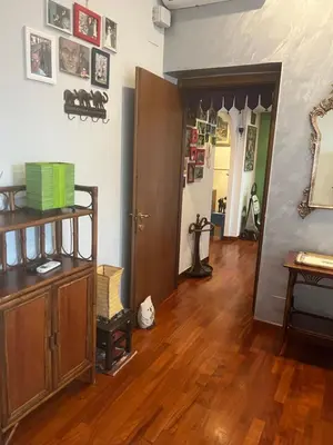 a living room with a wooden floor and a hallway at House Candia 111 - Vatican Museum apartment in Rome