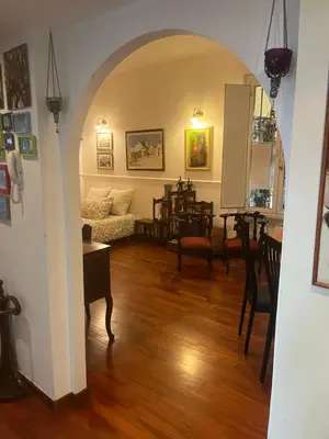a living room with an archway with a couch and a table at House Candia 111 - Vatican Museum apartment in Rome