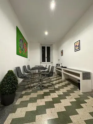 a room with a table and chairs and a piano at B&B Una notte a Mazzini in Rome