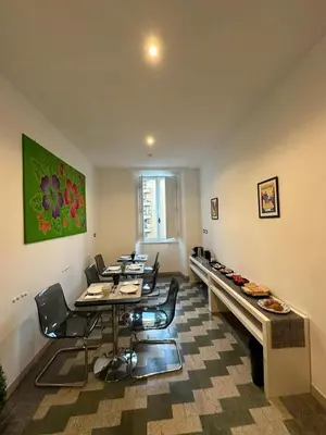 a dining room with tables and chairs in a room at B&B Una notte a Mazzini in Rome