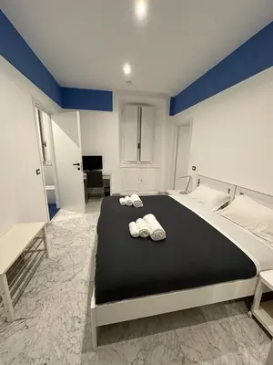 a bedroom with a large bed with two towels on it at B&B Una notte a Mazzini in Rome