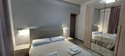 a bedroom with a large bed and a mirror at MCM in Rome
