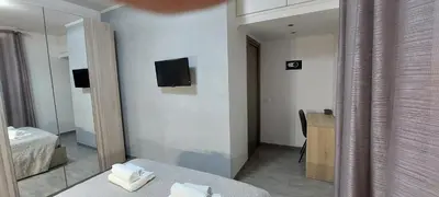 a room with a mirror and a bed and a desk at MCM in Rome