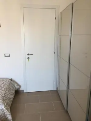 a door in a room with a bed and a closet at Casa Grimaldi in Rome