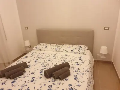 a bedroom with a bed with two towels on it at Casa Grimaldi in Rome