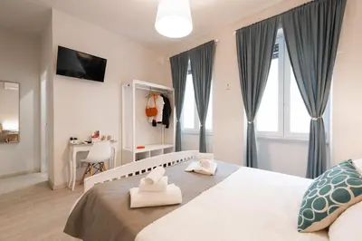 a bedroom with a large bed with towels on it at Winkler Suites in Rome