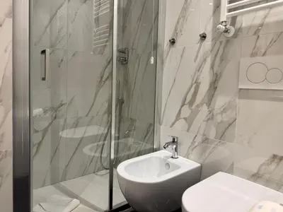 a bathroom with a sink and a shower and a toilet at Room Roma Nazionale in Rome