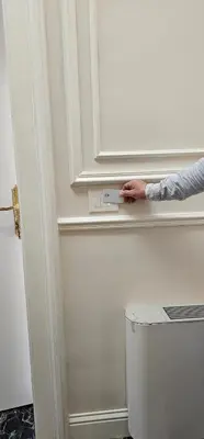 a person reaching for a door handle on a wall at Room Roma Nazionale in Rome