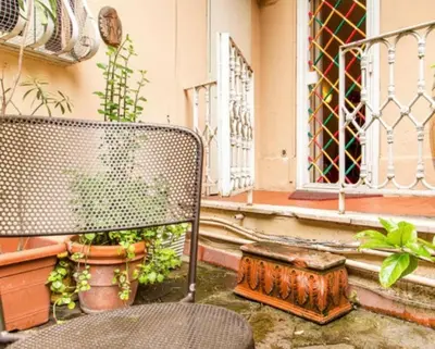 a bench sitting in front of a building with plants at Charming Studio near the Colosseum in Rome, 45 m² with Balcony in Rome