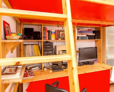 a book shelf with a computer and a desk at Charming Studio near the Colosseum in Rome, 45 m² with Balcony in Rome