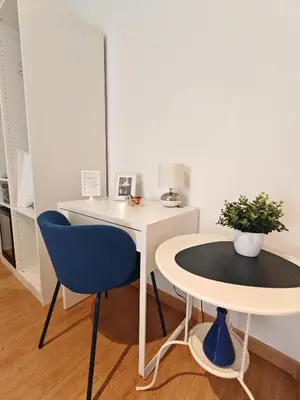 a white desk with a blue chair and a table at AD Trastevere Guest House - by AD Roma in Rome