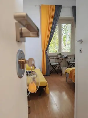 a room with a bed and a table and a window at AD Trastevere Guest House - by AD Roma in Rome