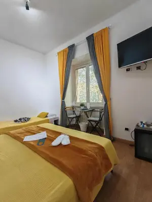 a hotel room with two beds and a flat screen tv at AD Trastevere Guest House - by AD Roma in Rome