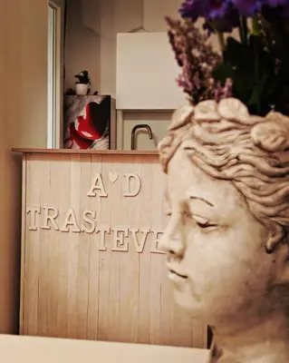 a statue of a head in front of a sign at AD Trastevere Guest House - by AD Roma in Rome