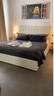 a large white bed with two towels on it at Testaccio historic house in Rome