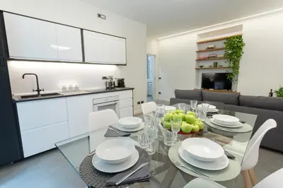 a kitchen and dining room with a glass table and chairs at Testaccio historic house in Rome