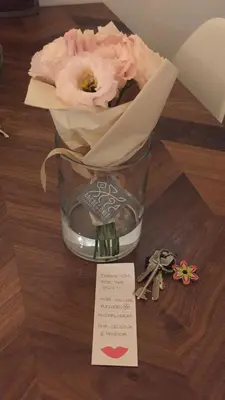 a rose in a glass with a note and keys at Testaccio historic house in Rome