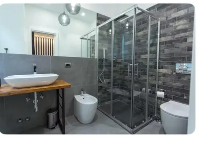 a bathroom with a sink and a shower and a toilet at Testaccio historic house in Rome