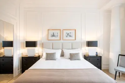 a bedroom with a large white bed with two night stands at Residenza B in Rome