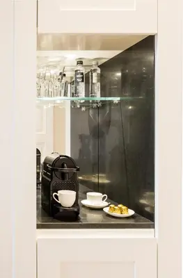 a coffee maker on a counter with a plate of food at Residenza B in Rome