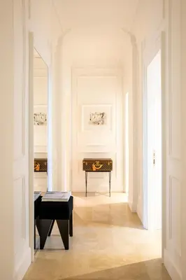 a hallway with a piano in a white room at Residenza B in Rome