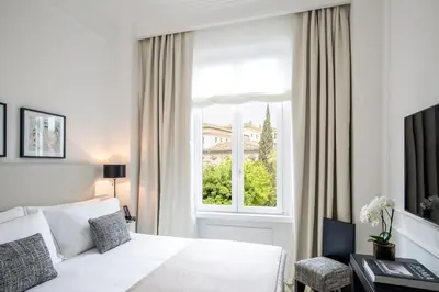 a bedroom with a white bed and a window at Residenza B in Rome