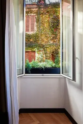 a window with a view of a building at NAMAN HOTELLERIE - Margutta in Rome