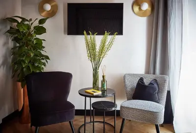 a living room with two chairs and a table at NAMAN HOTELLERIE - Margutta in Rome