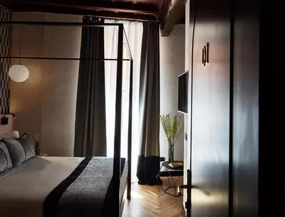 a bedroom with a bed and a sliding glass door at NAMAN HOTELLERIE - Margutta in Rome