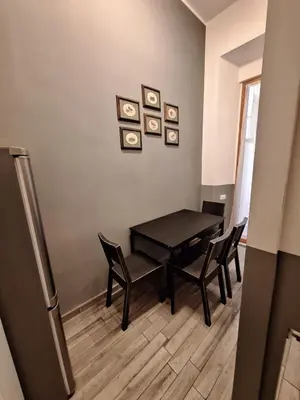 a dining room with a black table and chairs at Vatican Tolemaide 2 in Rome