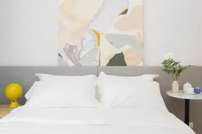 a bedroom with a bed with white pillows at The Radical Hotel Roma in Rome