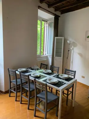 a table with chairs and plates on it in a room at Navona Relais - Center of Rome in Rome