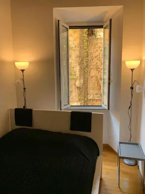 a bedroom with a bed and a window at Navona Relais - Center of Rome in Rome