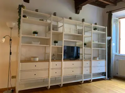 a large white book shelf with a tv on it at Navona Relais - Center of Rome in Rome