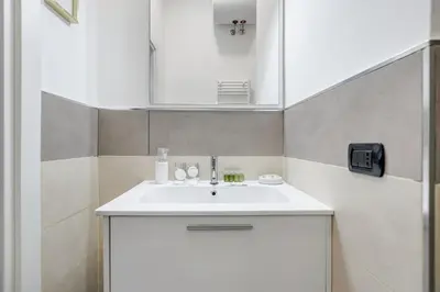 a bathroom with a white sink and a mirror at Maison Risorgimento in Rome